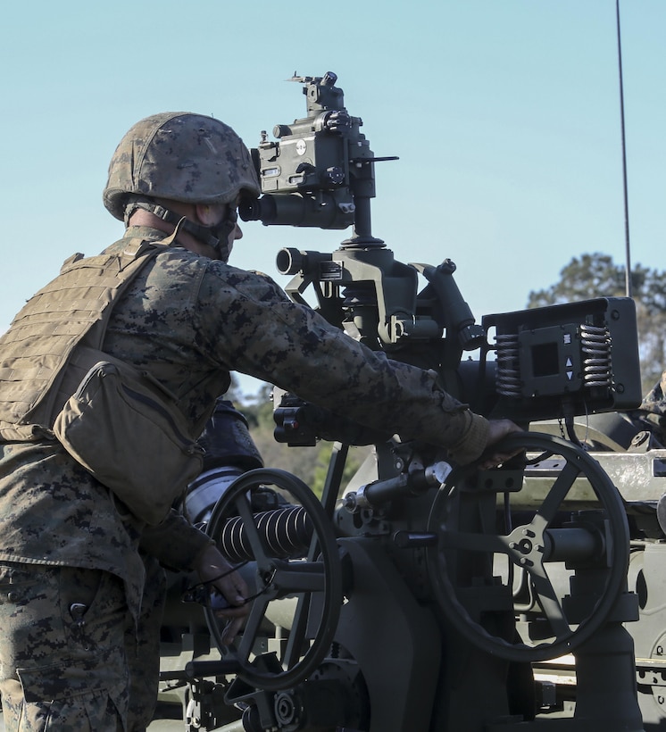 Cpl. Jesse Arthur, a field artillery cannoneer with, 3rd Battalion, 14th Marine Regiment observes a firing position during a live-fire exercise as part of exercise Saipan Rain at Camp Lejeune, N.C., March 30, 2016. The battery, based out of Navy Operational Support Center, Richmond, Va., joined forces with 10th Marine Regiment to support operations during the exercise. (U.S. Marine Corps photo by Cpl. Paul S. Martinez/Released)