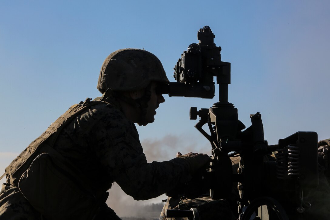 Cpl. Jesse Arthur, a field artillery cannoneer with 3rd Battalion, 14th Marine Regiment observes a firing position during a live-fire exercise as part of exercise Saipan Rain at Camp Lejeune, N.C., March 30, 2016. The battery, based out of Navy Operational Support Center, Richmond, Va., joined forces with 10th Marine Regiment to support operations during the exercise. (U.S. Marine Corps photo by Cpl. Paul S. Martinez/Released)