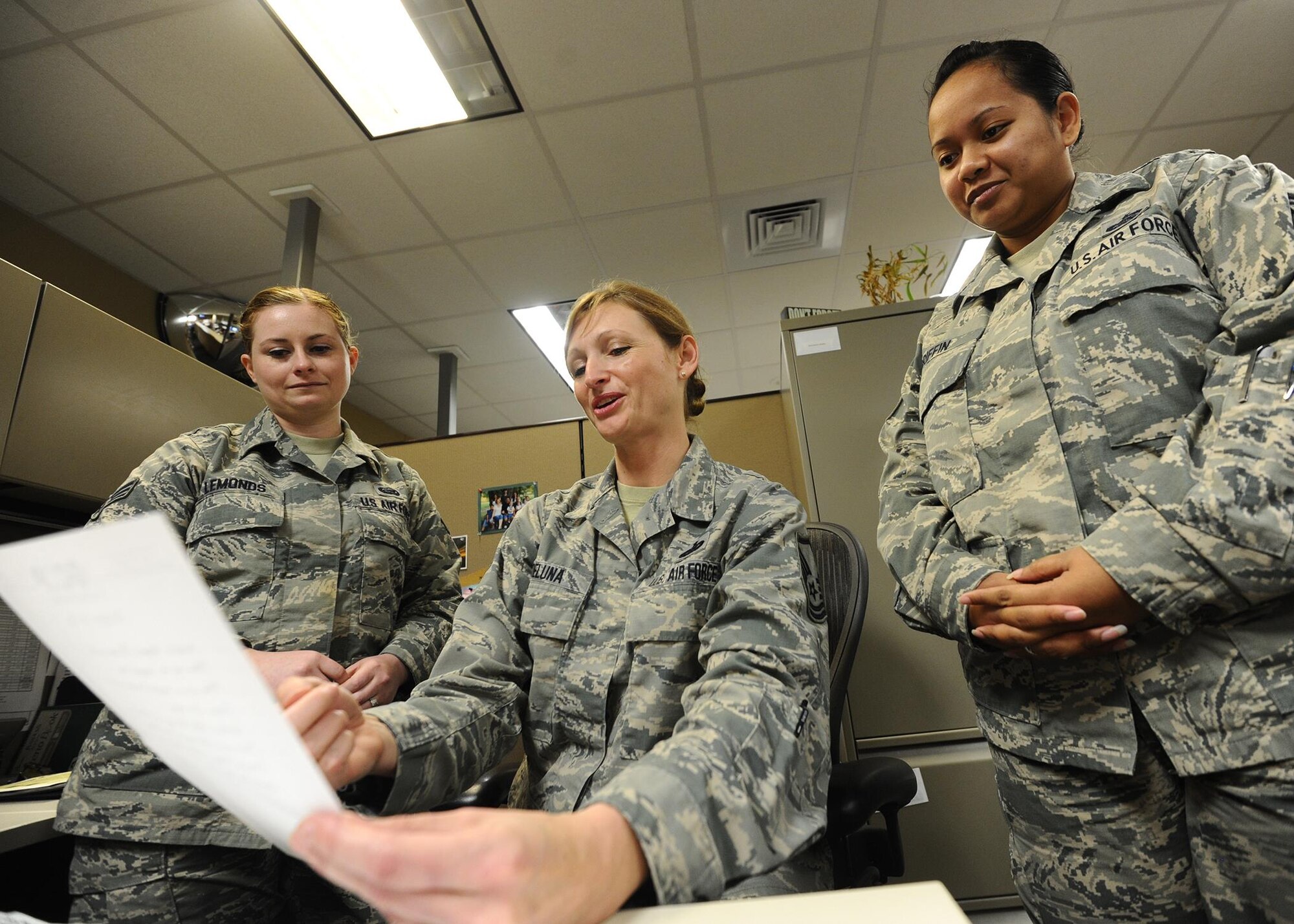 Master Sgt. Tricia DeLuna, AFNORTH force management branch manager, reviews manpower documents with Senior Airman Charlott Lemonds, AFNORTH career development technician and Staff Sgt. Delayne Griffin, AFNORTH force management branch NCO in-charge, April 4 at the Killey Center for Homeland Operations. DeLuna, Lemonds and Griffin work within the A1-manpower and personnel section as well as manage all AFNORTH personnel related concerns.