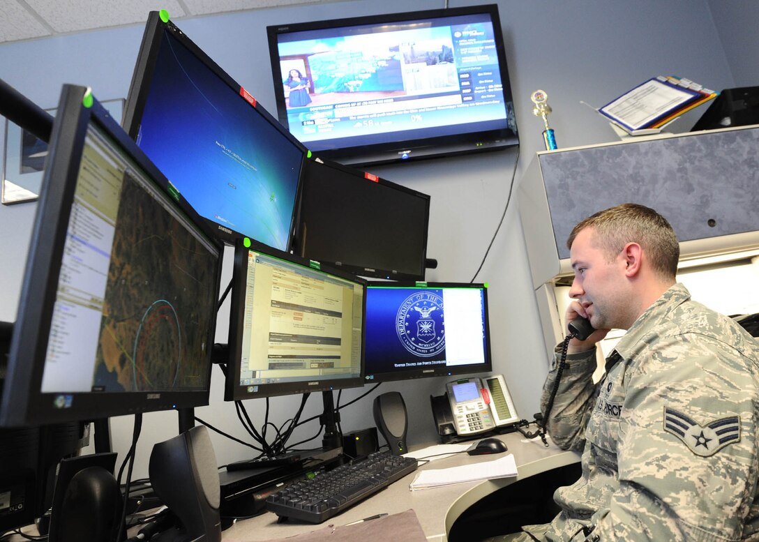 Senior Airman Dakota Powers, Air Force Rescue Coordination Controller, monitors computer screens while taking a phone call April 5 at the 601st Air Operations Center. The facility is staffed 24/7 to respond to, and coordinate rescue operations. 