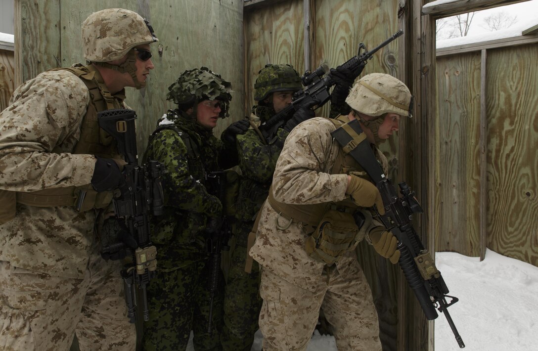 Cpl. Joseph A. Childs (right), a team leader with 1st Platoon, Company I, 3rd Battalion, 25th Marine Regiment, 4th Marine Division, Marine Forces Reserve, leads a fire team of Marines and soldiers from the Danish Home Guard through a room clearing drill during exercise Arctic Eagle at Camp Grayling, Mich., April 6, 2016. The Marines joined soldiers with the U.S. Army National Guard and the Danish Home Guard in the bilateral exercise, designed to simulate a joint task force defending key infrastructure in the arctic region. (U.S. Marine Corps photo by Cpl. Ian Leones/Released)