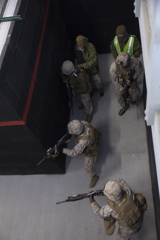 Marines with Company I, 3rd Battalion, 25th Marine Regiment, 4th Marine Division, Marine Forces Reserve, clear a hallway during a room clearing drill during exercise Arctic Eagle at Camp Grayling, Mich., April 6, 2016. The Marines joined soldiers with the U.S. Army National Guard and the Danish Home Guard in the bilateral exercise, designed to simulate a joint task force defending key infrastructure in the arctic region. (U.S. Marine Corps photo by Cpl. Ian Leones/Released)