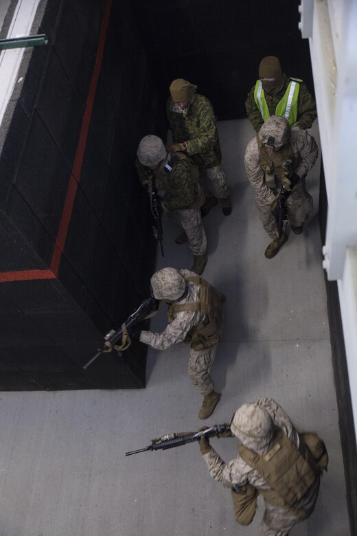 Marines with Company I, 3rd Battalion, 25th Marine Regiment, 4th Marine Division, Marine Forces Reserve, clear a hallway during a room clearing drill during exercise Arctic Eagle at Camp Grayling, Mich., April 6, 2016. The Marines joined soldiers with the U.S. Army National Guard and the Danish Home Guard in the bilateral exercise, designed to simulate a joint task force defending key infrastructure in the arctic region. (U.S. Marine Corps photo by Cpl. Ian Leones/Released)
