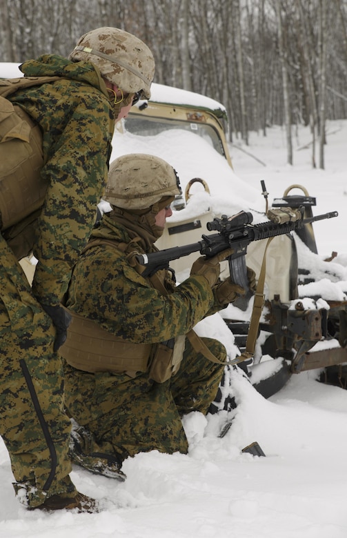 Cpl. Cody J. Shepard (right), a squad leader with Weapons Platoon, Company I, 3rd Battalion, 25th Marine Regiment, 4th Marine Division, Marine Forces Reserve, reloads his M4 assault rifle while conducting a live-fire “react to contact” drill.  The Marines joined soldiers with the U.S. Army National Guard and the Danish Home Guard in the bilateral exercise, designed to simulate a joint task force defending key infrastructure in the arctic region. (U.S. Marine Corps photo by Cpl. Ian Leones/Released)