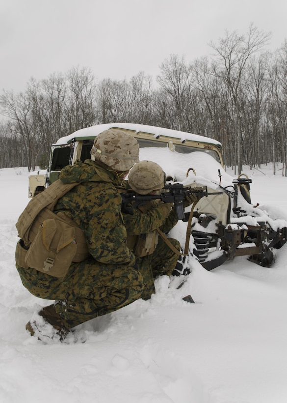 Cpl. Cody J. Shepard (right), a squad leader with Weapons Platoon, Company I, 3rd Battalion, 25th Marine Regiment, 4th Marine Division, Marine Forces Reserve, fires at a target during a live-fire “react to contact” drill during exercise Arctic Eagle at Camp Grayling, Mich., April 6, 2016. The Marines joined soldiers with the U.S. Army National Guard and the Danish Home Guard in the bilateral exercise, designed to simulate a joint task force defending key infrastructure in the arctic region. (U.S. Marine Corps photo by Cpl. Ian Leones/Released)