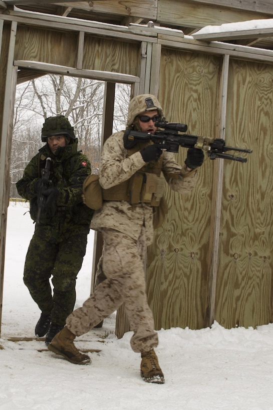 Lance Cpl. John R. Ehr (right), a rifleman with 1st Platoon, Company I, 3rd Battalion, 25th Marine Regiment, 4th Marine Division, Marine Forces Reserve, enters a room during a room clearing drill during exercise Arctic Eagle at Camp Grayling, Mich., April 6, 2016. The Marines joined soldiers with the U.S. Army National Guard and the Danish Home Guard in the bilateral exercise, designed to simulate a joint task force defending key infrastructure in the arctic region. (U.S. Marine Corps photo by Cpl. Ian Leones/Released)