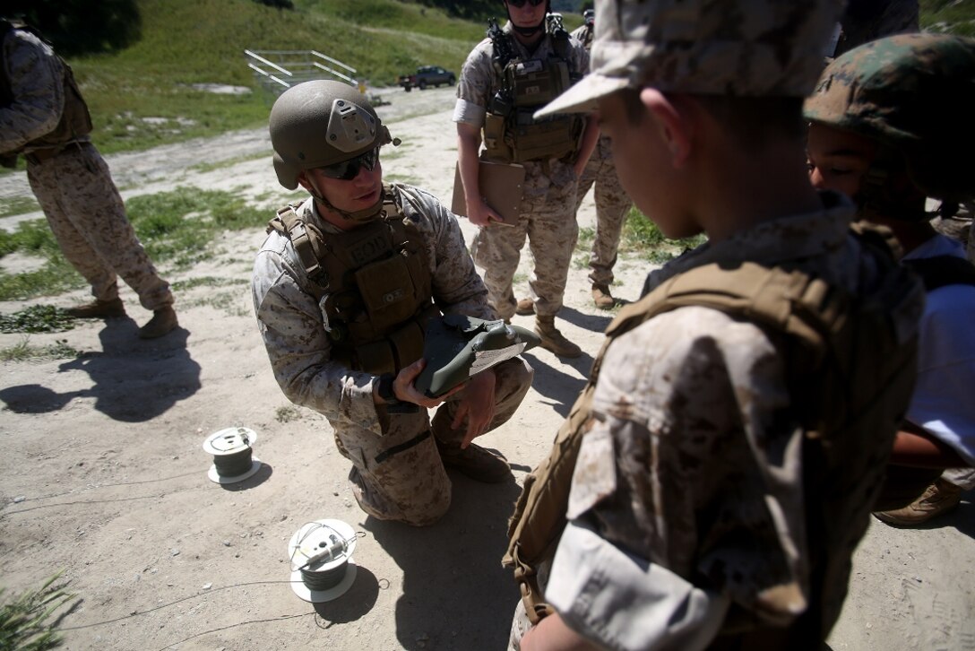 Nathan Aldaco, a 12 year-old boy with hypoplastic left heart syndrome, learns about the power of blasting caps during a Make-A-Wish event supported by 7th Engineer Support Battalion, 1st Marine Logistics Group, aboard Camp Pendleton, Calif., March 24, 2016. Marines with 7th ESB and Explosive Ordnance Disposal helped to make Nathan’s wish of becoming a Marine come true by demonstrating the capabilities of their EOD robots and detonating TNT, C4, dynamite and blasting caps, while the heavy equipment operators gave him the opportunity to ride the D7 dozer and the excavator, in which he dug a pit, built a berm, and broke several large tree trunks.  (U.S. Marine Corps photo by Sgt. Laura Gauna/released)