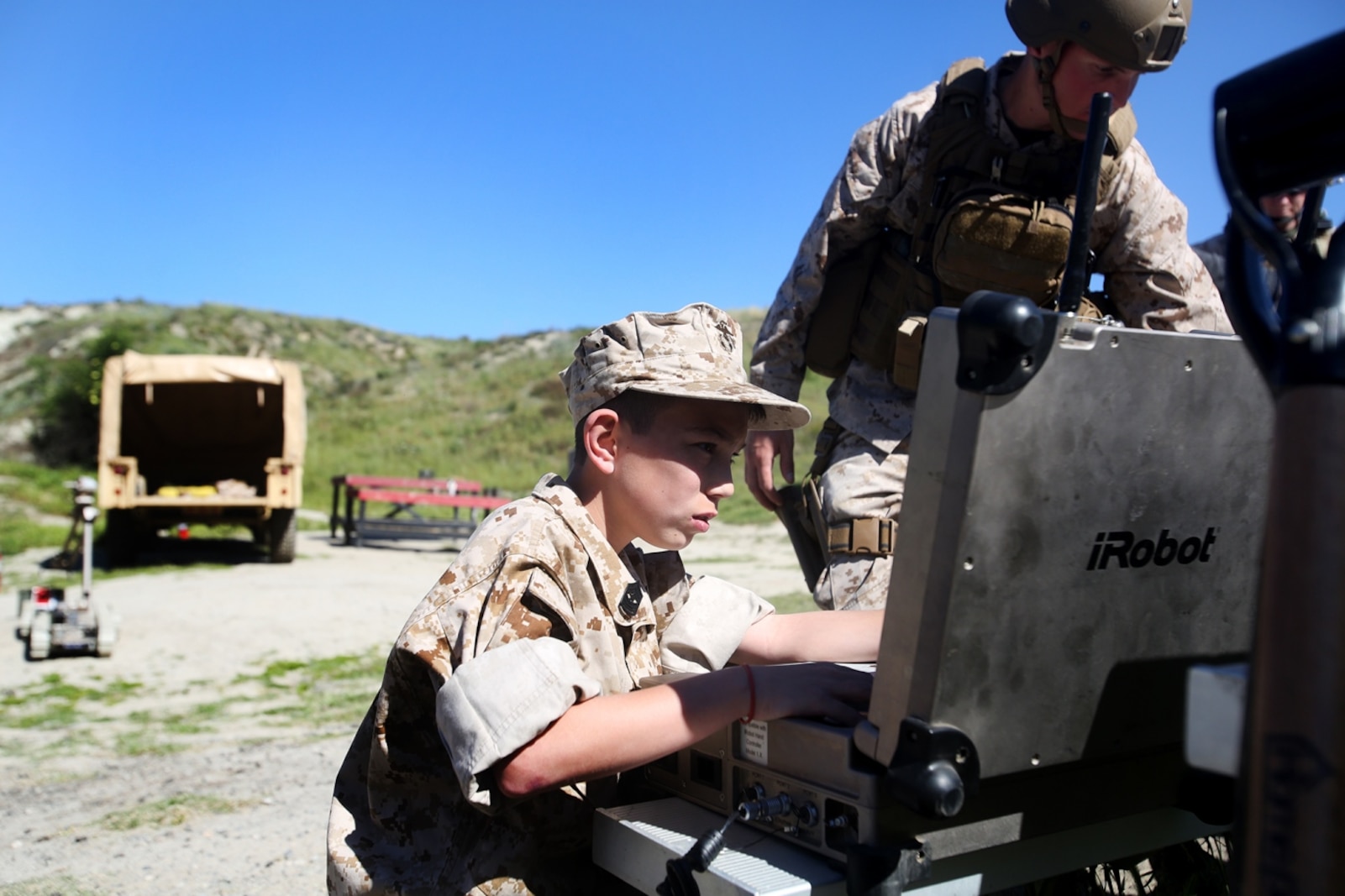 Nathan Aldaco, a 12 year-old boy with hypoplastic left heart syndrome, controls a Pacbot during a Make-A-Wish event supported by 7th Engineer Support Battalion, 1st Marine Logistics Group, aboard Camp Pendleton, Calif., March 24, 2016. Marines with 7th ESB and Explosive Ordnance Disposal helped to make Nathan’s wish of becoming a Marine come true by demonstrating the capabilities of their EOD robots and detonating TNT, C4, dynamite and blasting caps, while the heavy equipment operators gave him the opportunity to ride the D7 dozer and the excavator, in which he dug a pit, built a berm, and broke several large tree trunks.  (U.S. Marine Corps photo by Sgt. Laura Gauna/released)