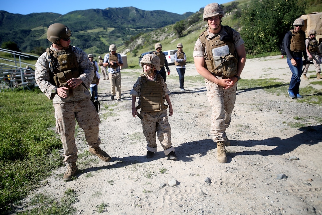 Nathan Aldaco, a 12 year-old boy with hypoplastic left heart syndrome, walks with Marines to a demolition site during a Make-A-Wish event supported by 7th Engineer Support Battalion, 1st Marine Logistics Group, aboard Camp Pendleton, Calif., March 24, 2016. Marines with 7th ESB and Explosive Ordnance Disposal helped to make Nathan’s wish of becoming a Marine come true by demonstrating the capabilities of their EOD robots and detonating TNT, C4, dynamite and blasting caps, while the heavy equipment operators gave him the opportunity to ride the D7 dozer and the excavator, in which he dug a pit, built a berm, and broke several large tree trunks.  (U.S. Marine Corps photo by Sgt. Laura Gauna/released)