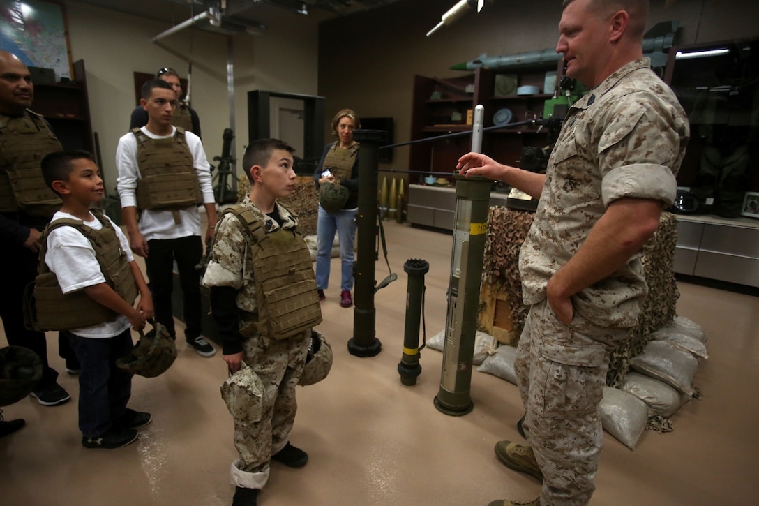 Nathan Aldaco, a 12 year-old boy with hypoplastic left heart syndrome, learns about explosive ordnance during a Make-A-Wish event supported by 7th Engineer Support Battalion, 1st Marine Logistics Group, aboard Camp Pendleton, Calif., March 24, 2016. Marines with 7th ESB and Explosive Ordnance Disposal helped to make Nathan’s wish of becoming a Marine come true by demonstrating the capabilities of their EOD robots and detonating TNT, C4, dynamite and blasting caps, while the heavy equipment operators gave him the opportunity to ride the D7 dozer and the excavator, in which he dug a pit, built a berm, and broke several large tree trunks.  (U.S. Marine Corps photo by Sgt. Laura Gauna/released)