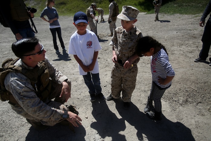 Nathan Aldaco, a 12 year-old boy with hypoplastic left heart syndrome, along with his brother and sister learn about TNT during a Make-A-Wish event supported by 7th Engineer Support Battalion, 1st Marine Logistics Group, aboard Camp Pendleton, Calif., March 24, 2016. Marines with 7th ESB and Explosive Ordnance Disposal helped to make Nathan’s wish of becoming a Marine come true by demonstrating the capabilities of their EOD robots and detonating TNT, C4, dynamite and blasting caps, while the heavy equipment operators gave him the opportunity to ride the D7 dozer and the excavator, in which he dug a pit, built a berm, and broke several large tree trunks.  (U.S. Marine Corps photo by Sgt. Laura Gauna/released)
