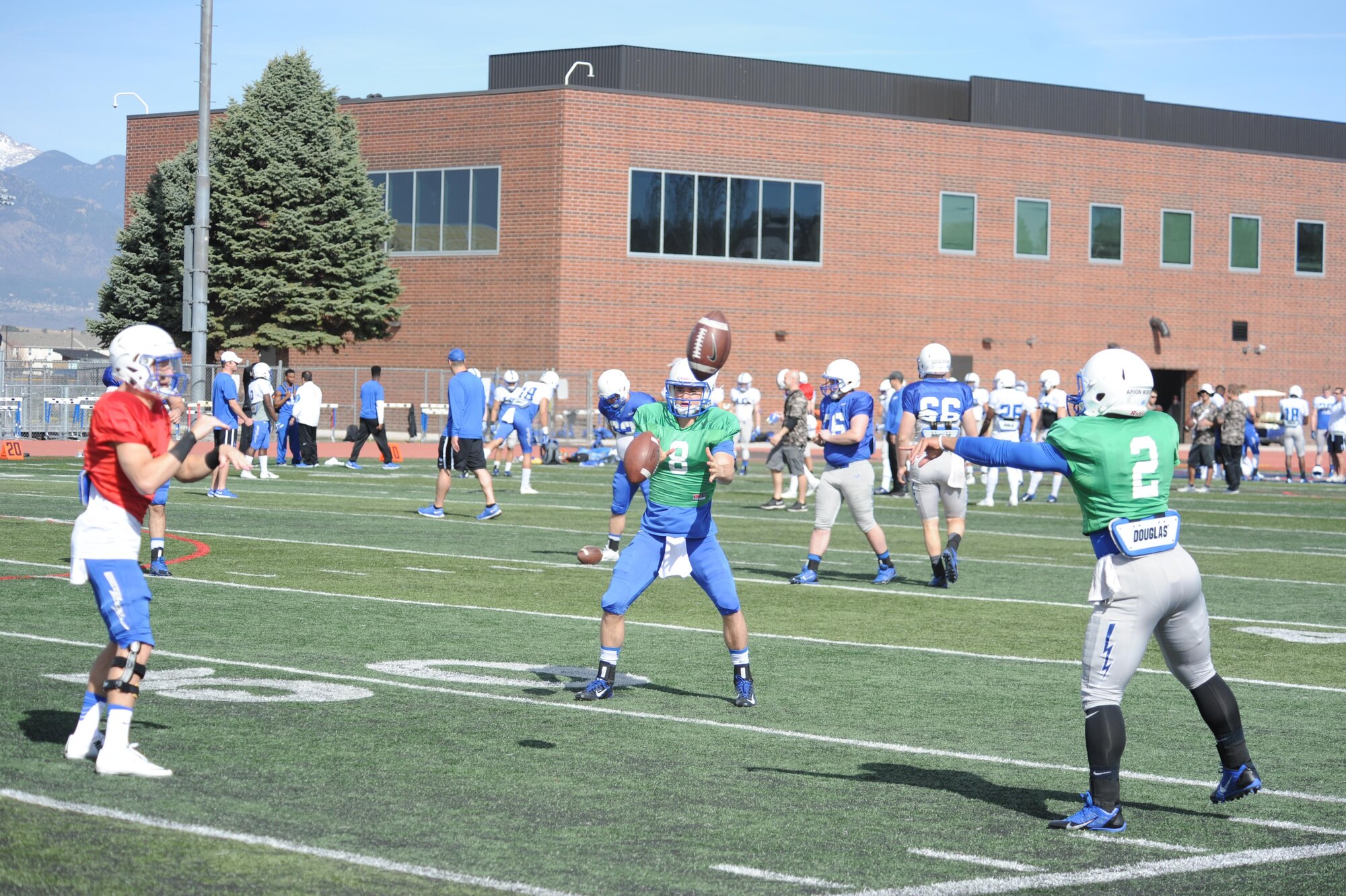 Air Force Academy quarterbacks (left to right) Nate Romine, Pate Davis and Arion Worthman practice a pitch drill to sharpen their reflexes prior to the start of the team's final scrimmage of spring football at Fountain-Fort Carson High School Stadium, April 9. (U.S. Air photo/John Van Winkle)