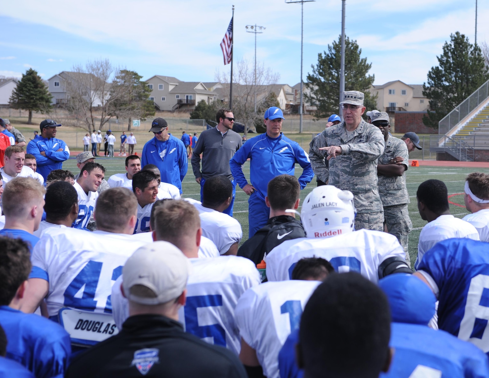 Gen. John Hyten, the commander of U.S. Air Force Space Command at Peterson Air Force Base, Colorado, chats with Falcons Football athletes April 9 at Fountain-Fort Carson High School. Air Force scrimmaged for about an hour and hosted members of Fort Carson and Peterson AFB in a flag football game. Air Force also hosted a youth autograph session and Air Force cheerleaders and the Bird mascot met fans. (U.S. Air Force photo/John Van Winkle) 