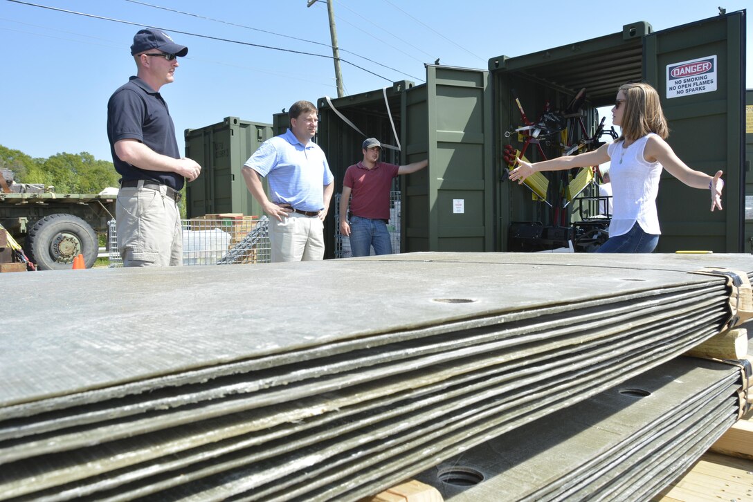 Haley Bell (right) of ERDC’s Geotechnical and Structures Laboratory, talks with Maj. Kelly Mattie of the USAF Civil Engineering Center (left), Jeb Tingle and Web Floyd of ERDC, during the Air Force Civil Engineering team’s visit to review the contents and packing of airfield damage repair kits.