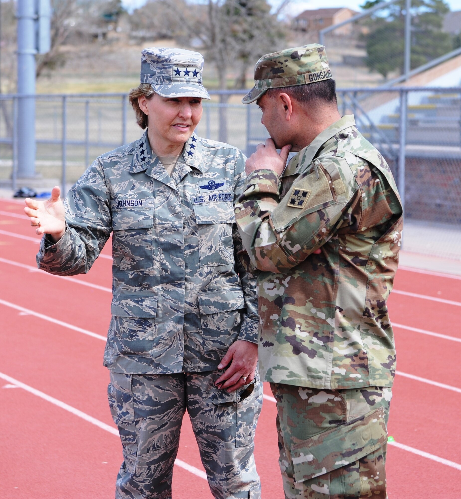 Lt. Gen. Michelle Johnson, the superintendent of the Air Force Academy, chats with Maj. Gen. Ryan Gonsalves, the  commander of Fort Carson Army Base, April 9, 2016, at Fountain-Fort Carson High School. Air Force hosted an hour-long flag-football scrimmage at the high school. Gen. John Hyten, commander of Air Force Space command, served as head coach with assistance from Col. Deanna Burt, commander of the 50th Space Wing at Schriever Air Force Base, and Col. Doug Schiess, the commander of the 21st Space Wing at Peterson AFB. Gonsalves led the other team. (U.S. Air Force photo/John Van Winkle)  