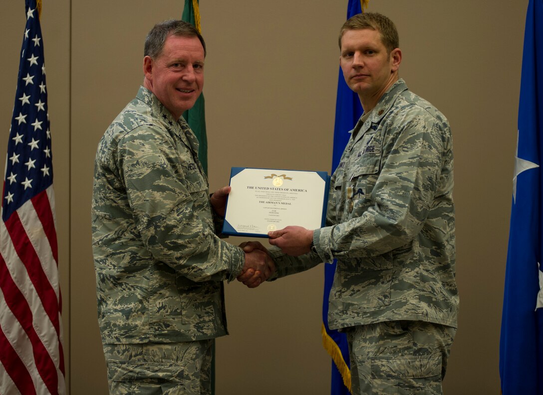 Maj. Matthew Arnold, 336th Training Group chief of standards evaluations, receives the Airman’s Medal during a ceremony April 8, 2016, at Fairchild Air Force Base, Wash. In 2013, Arnold and Criswell were participating in a routine training exercise in Okinawa, Japan when an HH-60G Pave Hawk went down. (U.S. Air Force photo/Airman 1st Class Sean Campbell)