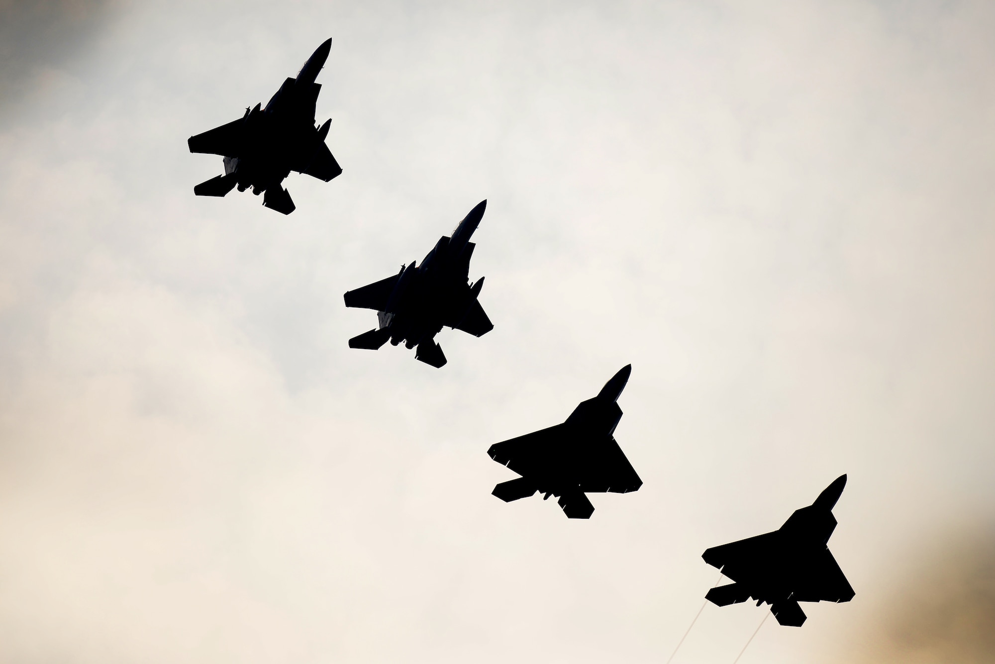 F-22 Raptors from the 95th Fighter Squadron conduct air-to-air training with F-15E Strike Eagles from the 494th Fighter Squadron April 11, at Royal Air Force Lakenheath, England. The training allows the perfect opportunity for the advanced aircraft to train alongside other U.S. Air Force aircraft, joint partners and NATO allies. (U.S. Air Force photo/ Tech. Sgt. Matthew Plew)
