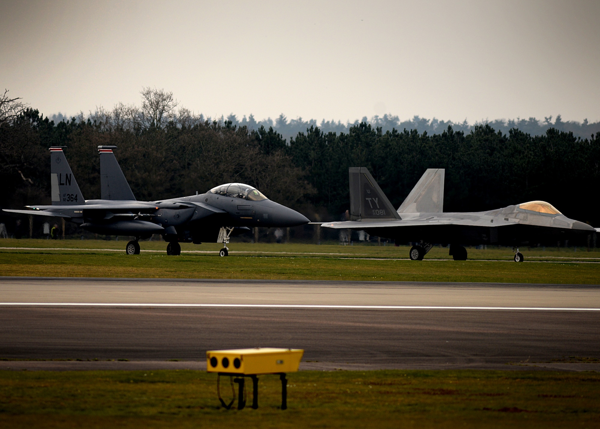 F-22 Raptors from the 95th Fighter Squadron land April 11, at Royal Air Force Lakenheath, 
England. The aircraft arrival marks the second time the U.S. European Command has hosted a deployment of F-22 aircraft in the EUCOM Area of Responsibility.  (U.S. Air Force photo/ Tech. Sgt. Matthew Plew)
