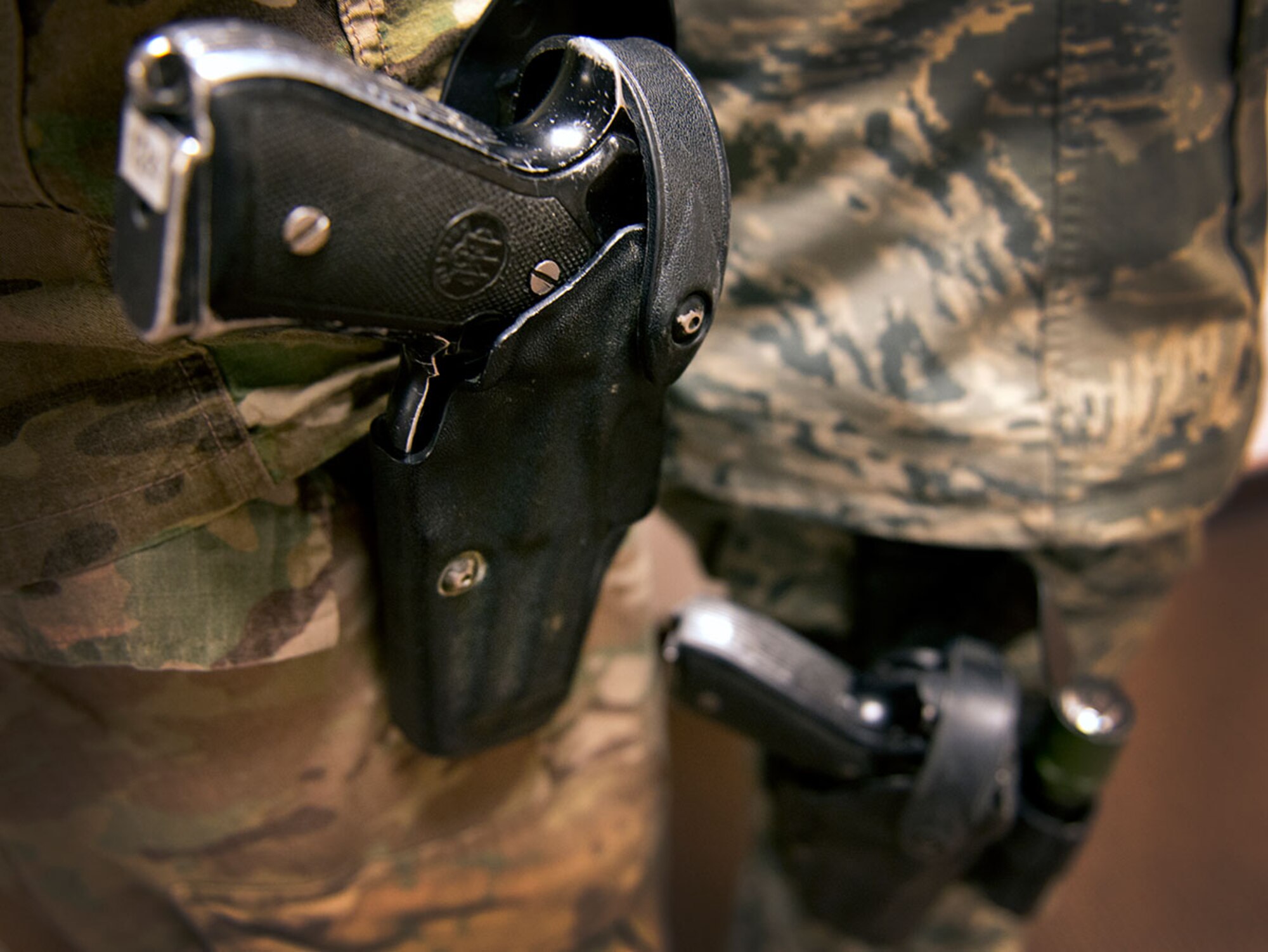 The Security Forces Staff arming program will allow approved military police Soldiers, security forces Airmen and defense force civilian personnel on Joint Base Elmendorf-Richardson working in staff positions at the office to carry weapons as they go about their daily tasks. Historically, only persons on patrol would be armed. This new initiative aims to make what is already considered a norm in the civilian sector normal operations in the military sector. (U.S. Air Force photo by Airman 1st Class Kyle Johnson)