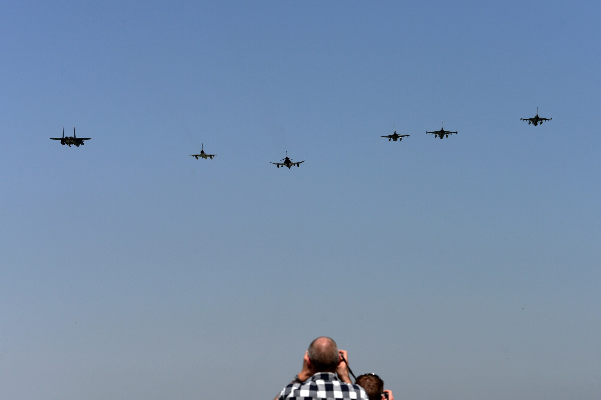 International media members take photos of a formation of aircraft from Hellenic, Israeli, and U.S. air forces, April 6, 2016, during exercise INIOHOS 16 at Andravida Air Base, Greece. INIOHOS 16 is a multi-nation exercise that enhances interoperability, capabilities, and skills amongst allied and partner air forces in the accomplishment of joint operations and air defenses, in order to maintain joint readiness and reassure regional allies and partners. (U.S. Air Force photo by Tech. Sgt. Eric Burks/Released)