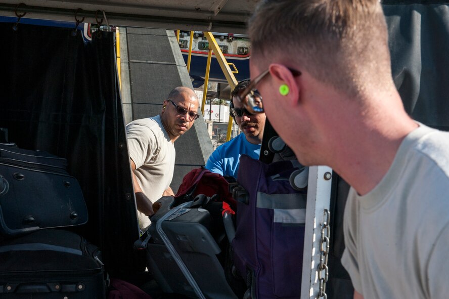 Members of the 728th Air Mobility Squadron load cargo April 1, 2016, at Incirlik Air Base, Turkey. The Secretary of Defense, in coordination with the Secretary of State, ordered the departure of all Department of Defense dependents assigned to Incirlik Air Base. (U.S. Air Force photo by Staff Sgt. Jack Sanders/Released)