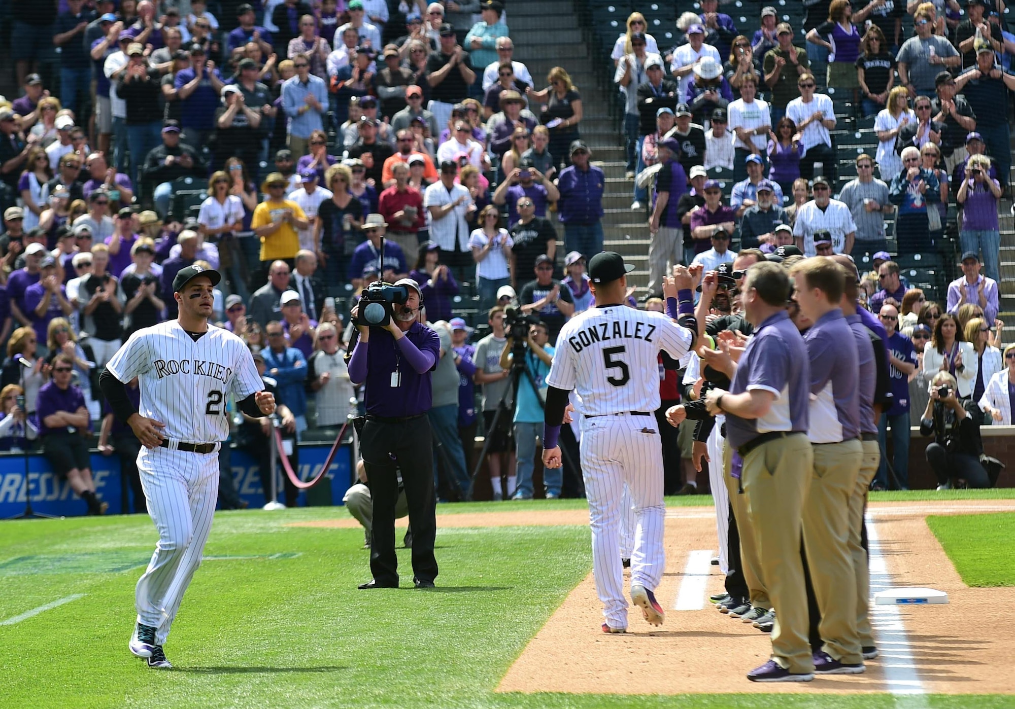 The Colorado Rockies held a military appreciation day April 8, 2016, during pre-game festivities at Coors Field in Denver, Colo. All branches of the military and the community’s civil servants, to include the police department and the county sheriff’s office, attended and participated in the day-long event. The ceremony included a joint color guard and a flag held by those in uniform. (U.S. Air Force photos by Airman 1st Class Gabrielle Spradling/Released)