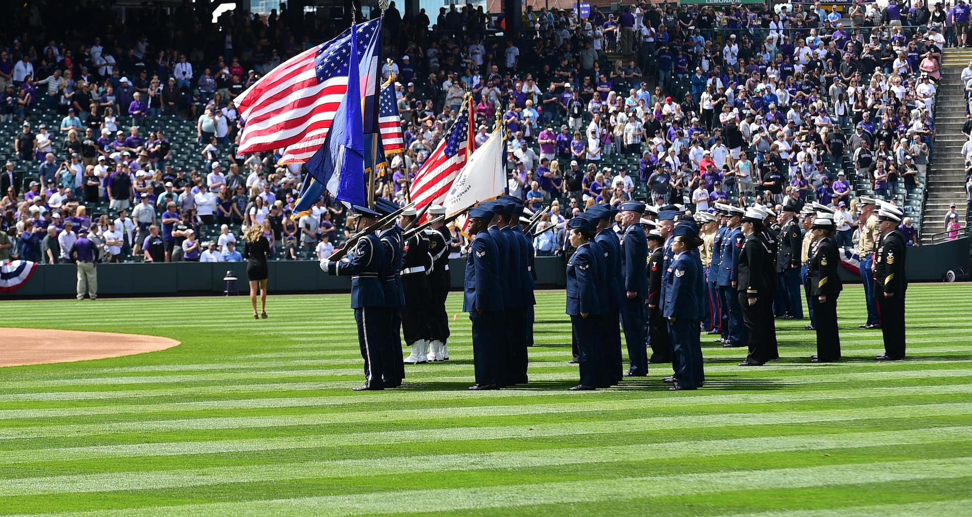 The Colorado Rockies held a military appreciation day April 8, 2016, during pre-game festivities at Coors Field in Denver, Colo. All branches of the military and the community’s civil servants, to include the police department and the county sheriff’s office, attended and participated in the day-long event. The ceremony included a joint color guard and a flag held by those in uniform. (U.S. Air Force photos by Airman 1st Class Gabrielle Spradling/Released)