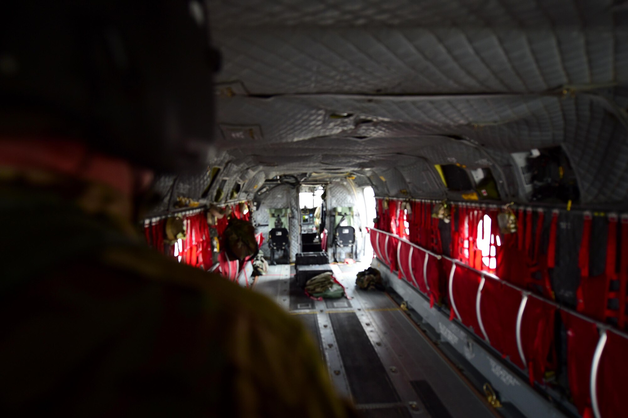 U.S. Army Sgt. 1st Class Guy Morgan, Detachment 1 Bravo standards instructor, looks into a CH-47 Chinook helicopter during a pre-flight inspection March, 31, 2016, at the Army Aviation Support Facility on Buckley Air Force Base, Colo. The entire aircraft must be inspected before and after every flight by Chinook crew members. (U.S. Air Force photo by Airman 1st Class Gabrielle Spradling/Released)