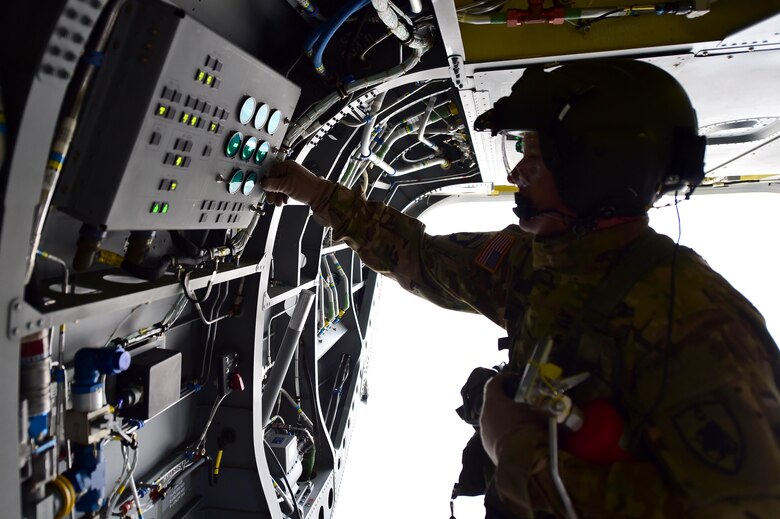 U.S. Army Sgt. 1st Class Guy Morgan, Detachment 1 Bravo standards instructor, checks the control panel during a pre-flight inspection March 31, 2016, at the Army Aviation Support Facility on Buckley Air Force Base, Colo. The flight instructor must be able to maintain the back of the aircraft in case a crew chief does not know what to do in any given situation. (U.S. Air Force photo by Airman 1st Class Gabrielle Spradling/Released)
