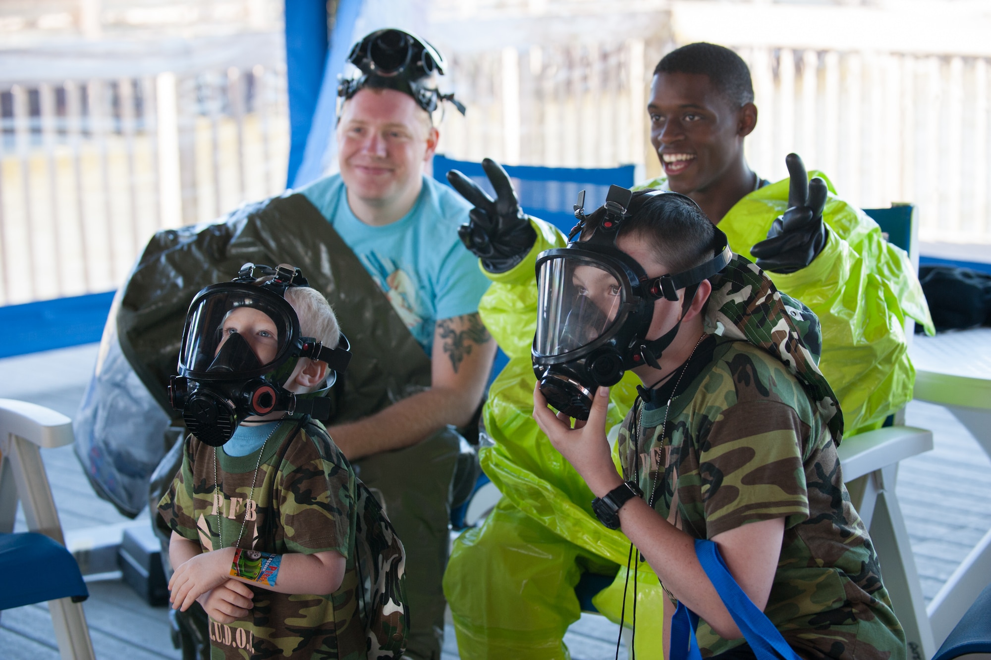 Children don chemical warfare gear during “Kids Understanding Deployment Operations,” held in conjunction with Play for a Day at Patrick Air Force Base, Fla, April 9.  KUDOS helped children of military families gain an understanding of what their parents go through before deployment. The 45th Force Support Squadron kicked off “Month of the Military Child with these events for 45th Space Wing families. (U.S. Air Force photo by Benjamin Thacker/Released)
