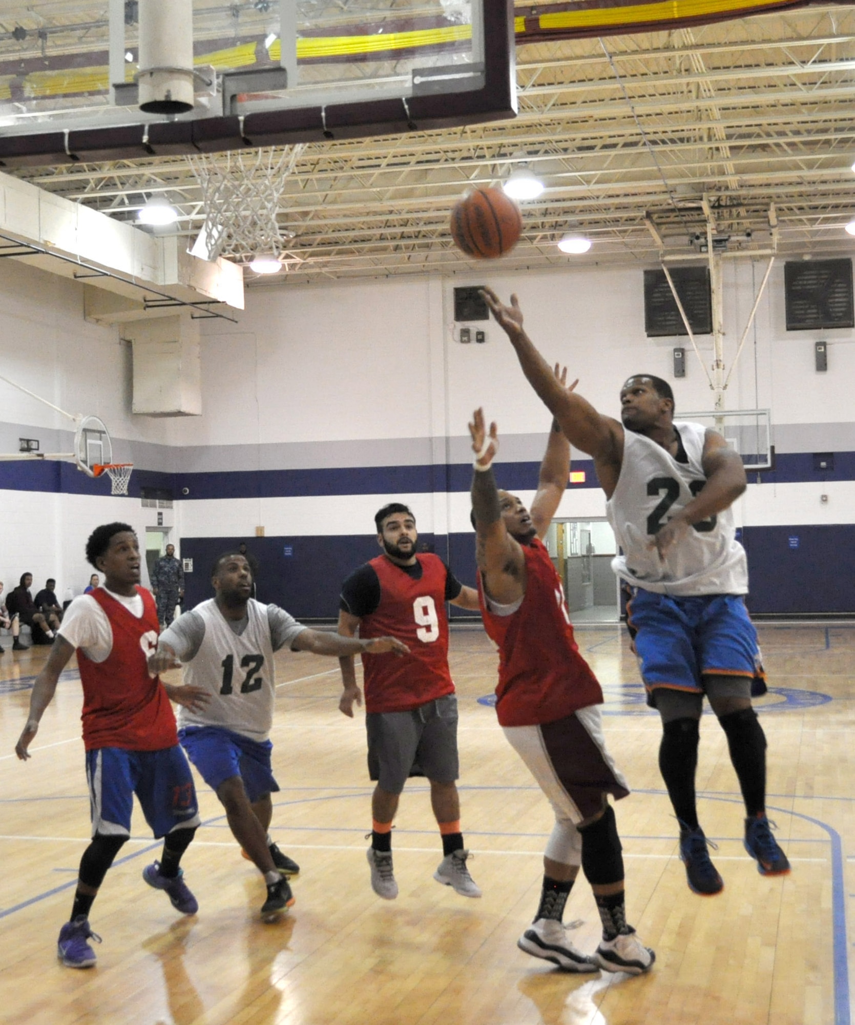Flight Controller Robert Lawrence floats the ball to the basket March 28 as his team beat Showtime 46-43 at the Gerrity Fitness Center. Showtime’s Jarail Smith is guarding him. The undefeated Flight Controllers are the top team in the Monday-Wednesday night league. (Air Force photo by John Parker/Released)