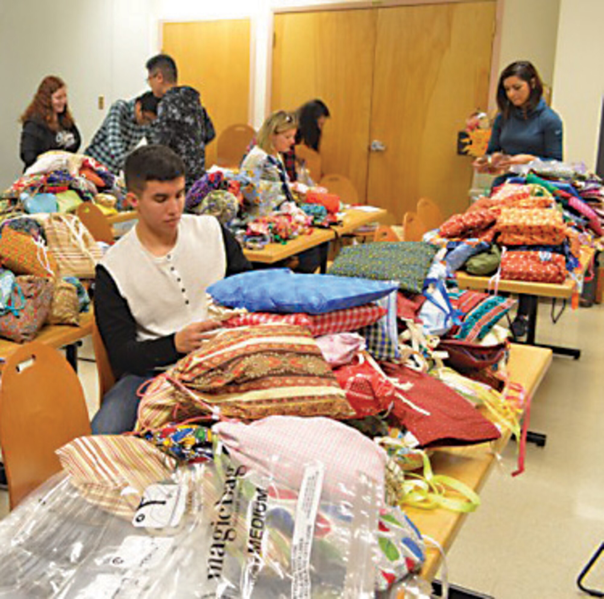 Volunteers from the 377th Medical Group sort hygiene items to prepare kits for girls in Nepal. The MDG joined the non-profit Women to Be to send the hygiene kits to Nepal in an effort to help empower Nepalese girls by providing items that will allow them to stay in school. (Courtesy photo)