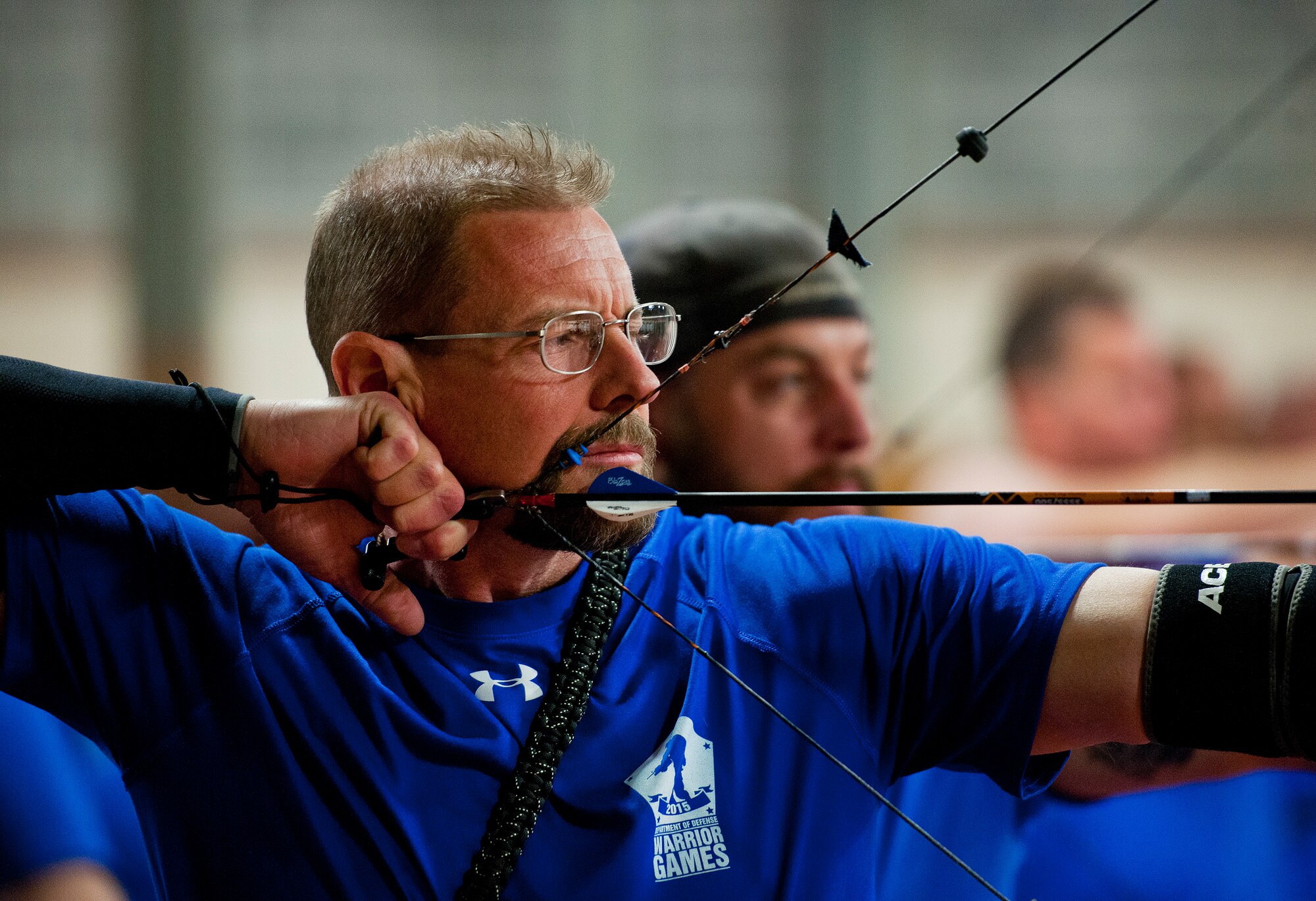 Scott Addington, a Warrior Games athlete, pulls back his bow string during a morning archery session at the Air Force team’s training camp at Eglin Air Force Base, Fla., April 8.  The base-hosted, week-long Warrior Games training camp was the last team practice session before the yearly competition in June.  (U.S. Air Force photo/Samuel King Jr.)