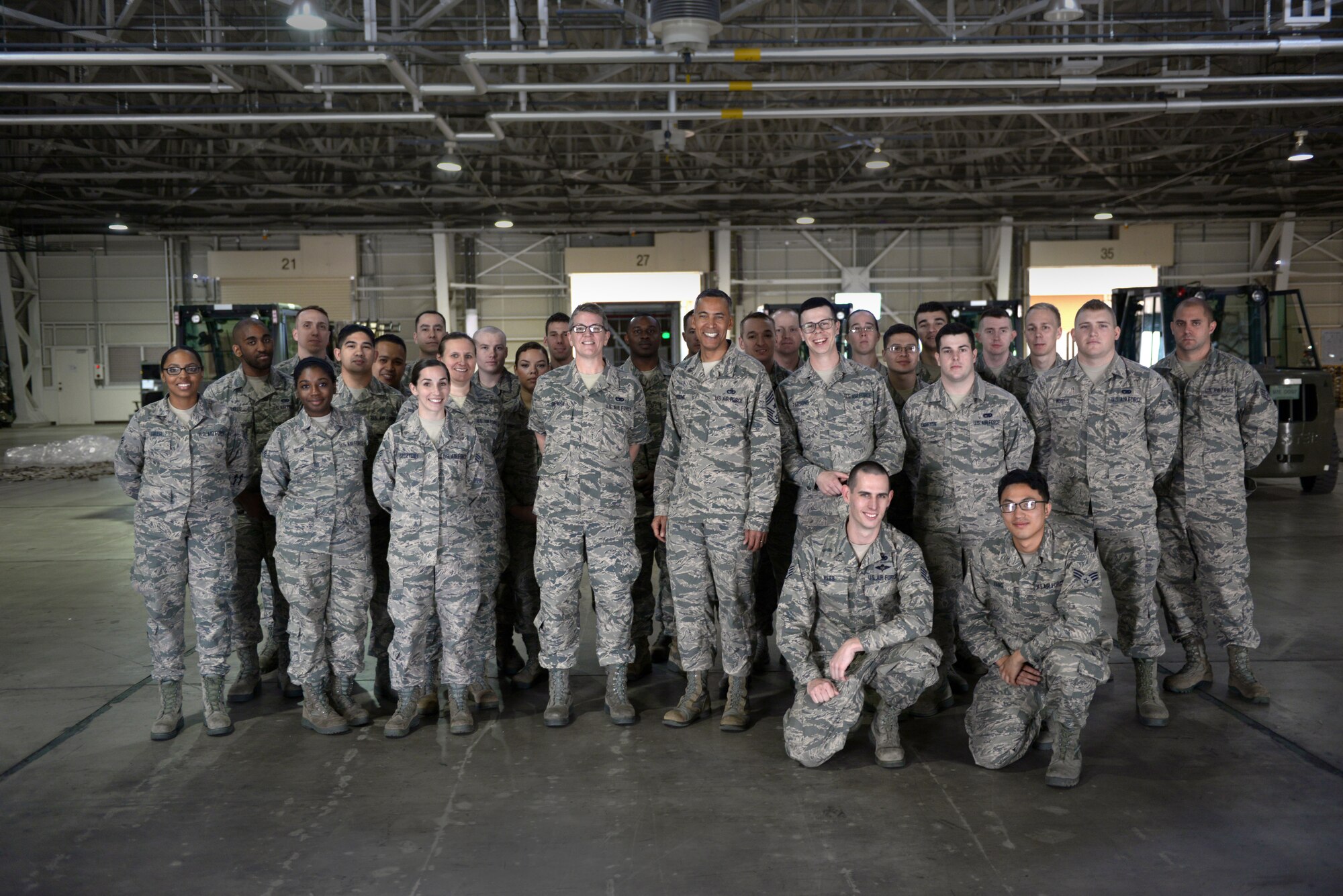 Chief Master Sgt. Terrence Greene, United States Forces, Japan and 5th Air Force command chief, stands with a group of Airmen during his immersion tour at Yokota Air Base, Japan, April 6, 2016. The Airmen are with the 730th Air Mobility Squadron at Yokota and the 74th Aerial Port Squadron from Lackland Air Force Base, Texas, who are conducting Air Force Reservist training here. (U.S. Air Force photo by Staff Sgt. Cody H. Ramirez/Released)