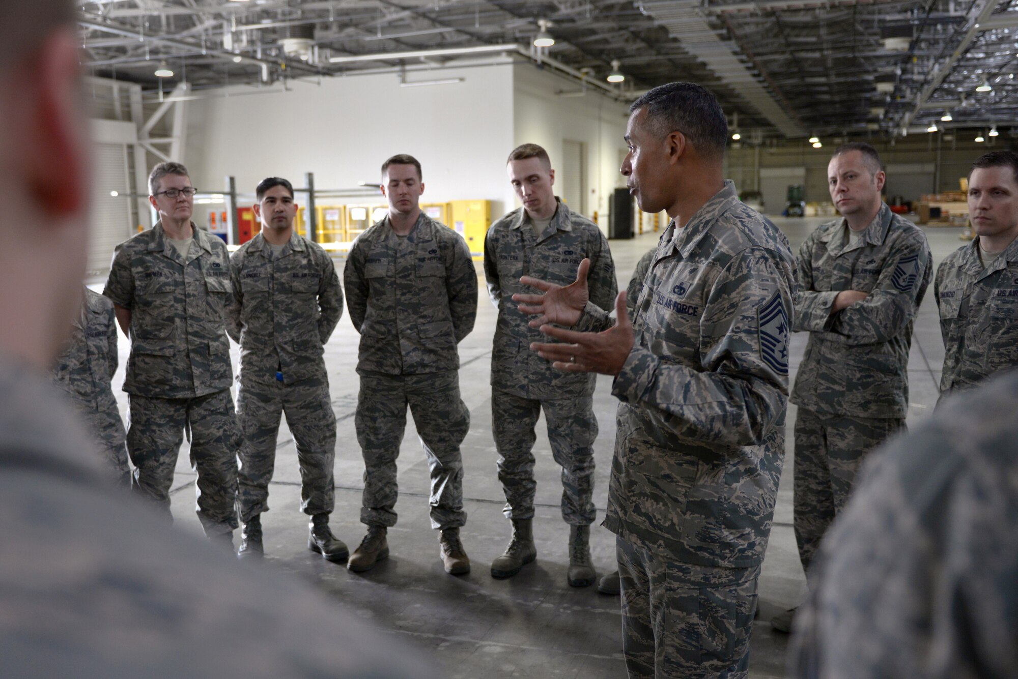 Chief Master Sgt. Terrence Greene, United States Forces, Japan and 5th Air Force command chief, speaks with Airmen during his immersion tour at Yokota Air Base, Japan, April 6, 2016. Greene, previously the command chief for the 51st Fighter Wing at Osan Air Base, Korea, is new to the position and used his tour to meet Airman at facilities across his new home installation. (U.S. Air Force photo by Staff Sgt. Cody H. Ramirez/Released)