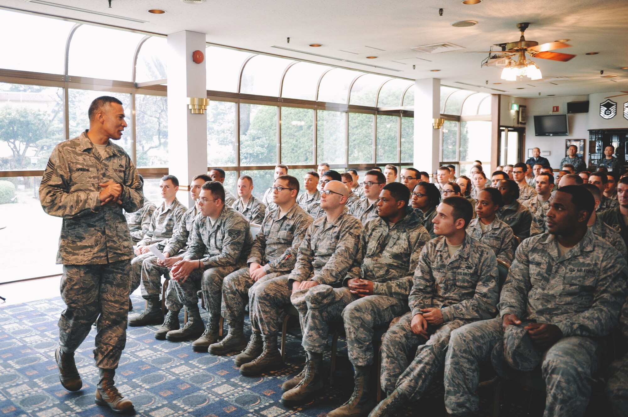 Chief Master Sgt. Terrence Greene, U.S. Forces, Japan and 5th Air Force command chief, speaks with Airmen of the First Four at Yokota Air Base, Japan, April 7, 2016. Greene spoke to Airmen about the importance of setting goals for the future as well as accomplishing their job to the best of their ability. (U.S. Air Force photo by Senior Airman Delano Scott/Released)