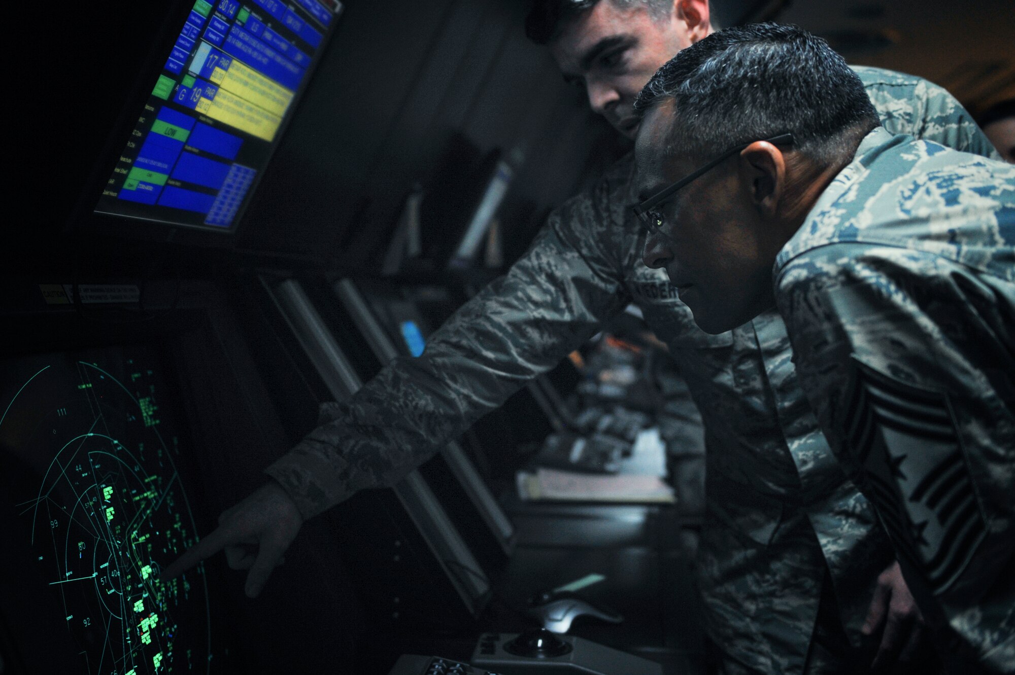 Chief Master Sgt. Terrence Greene, U.S. Forces, Japan and 5th Air Force command chief, oversees a radar approach control section of the 374th Operations Support Squadron air traffic control tower at Yokota Air Base, Japan, April 6, 2016. Greene, the previous command chief for the 51st Fighter Wing at Osan Air Base, Korea, is new to the position and used his tour to greet Airman at facilities across his new home installation. (U.S. Air Force photo by Senior Airman Delano Scott/Released)