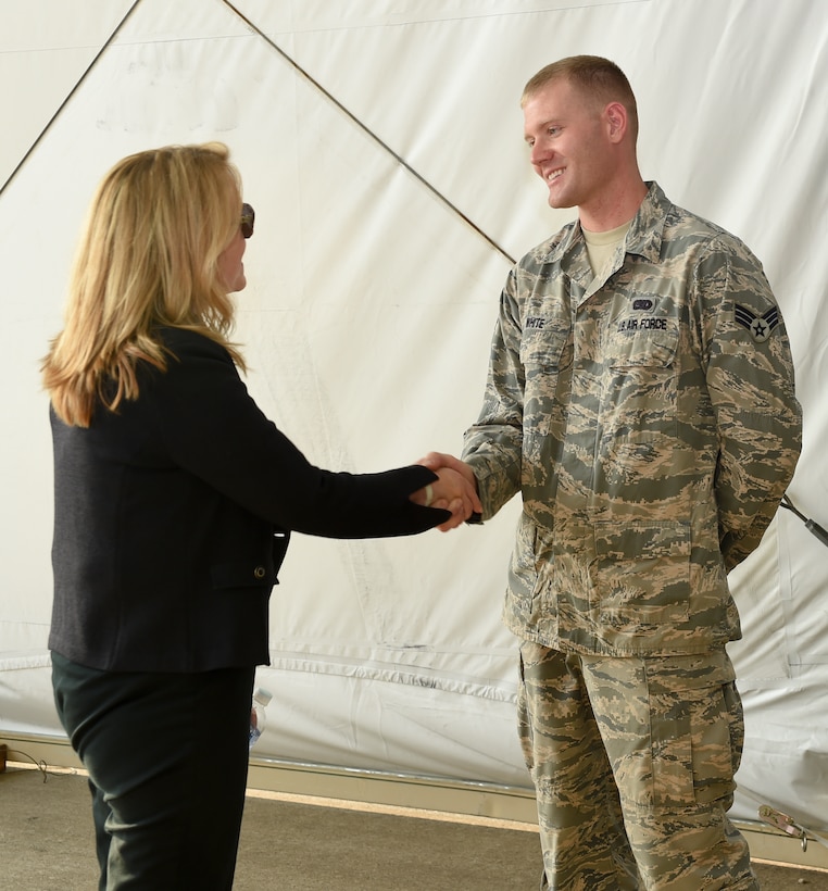 U.S. Air Force Senior Airman Charles White, 612th Air Base Squadron Logistics Flight vehicle maintainer, shakes hands with Secretary of the Air Force Deborah Lee James Apr. 8, 2016, at Soto Cano Air Base, Honduras. White, a native of Coeur d’Alene, Idaho, supports the mission at Joint Task Force-Bravo by ensuring vehicles are maintained and operational to help conduct firefighting operations, receive transient aircraft, load and offload cargo, and basic base transportation. (U.S. Army photo by Martin Chahin/Released)