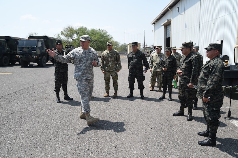 Chief Warrant Officer 2 Marco Rodriguez, Joint Task Force-Bravo Logistics Coordinator, provides an information briefing about Motor Pool operations and maintenance for members of the Honduran Logistics Command (CALFA), Soto Cano Air Base, Honduras, April 1, 2016. During the visit, Honduran Col. José Antonio Rodriguez Mencia, CALFA commander, learned about the different transportation and vehicle capabilities JTF-Bravo uses to mobilize troops and equipment.  (U.S. Army photo by Martin Chahin/RELEASED)

