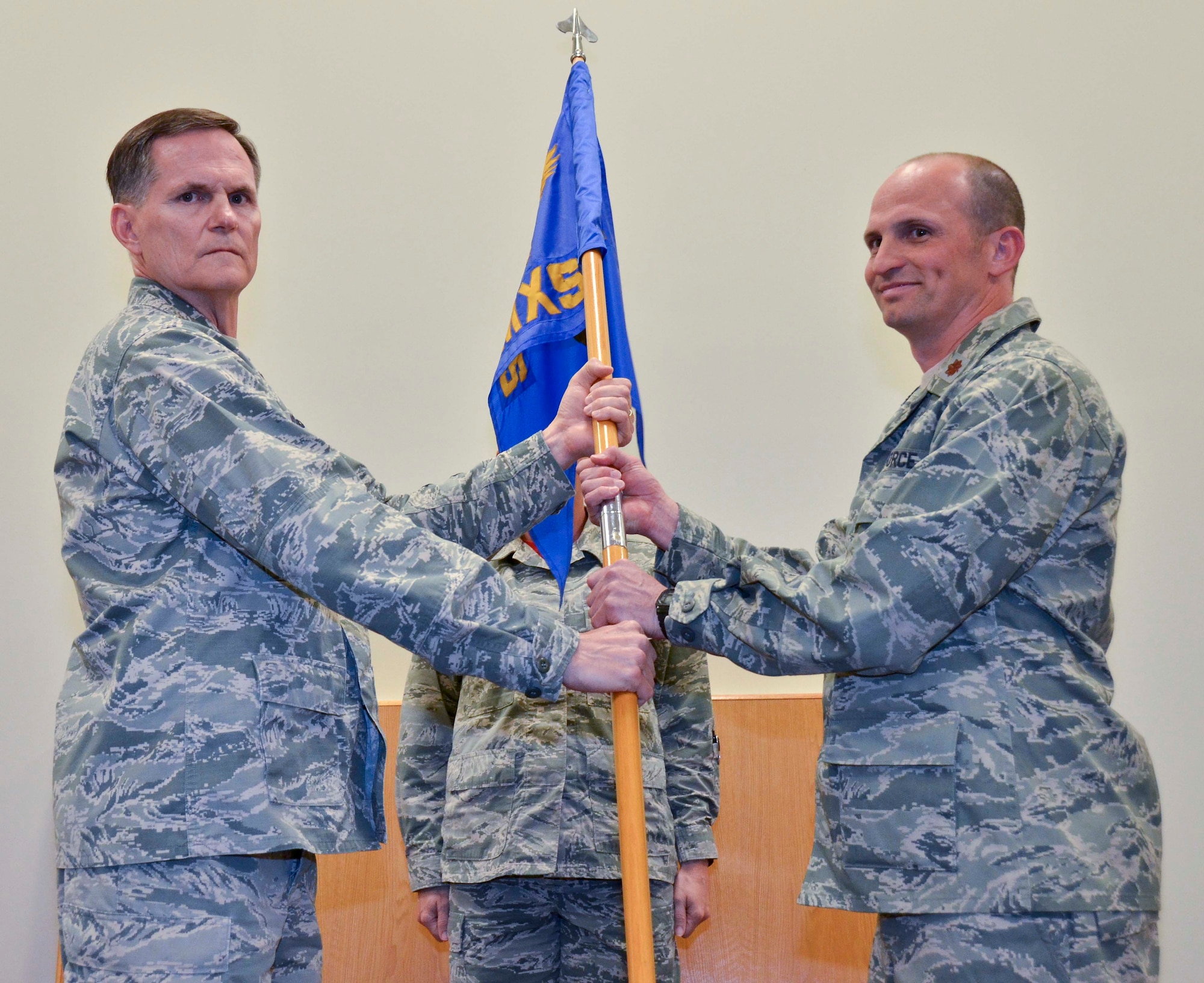 Maj. Steen Milne assumes command of the 117th Aircraft Maintenance Squadron under the guidance of Col. Anthony Johnson, Commander of the 117th Maintenance Group, on April 9, 2016, in Birmingham, Ala. Milne started out in maintenance as an electrician and was deployed after 9/11. Several years later he was hired to be a pilot part-time and continued to work as a full-time teacher. (Air National Guard photo by Senior Airman Wes Jones/Released)
