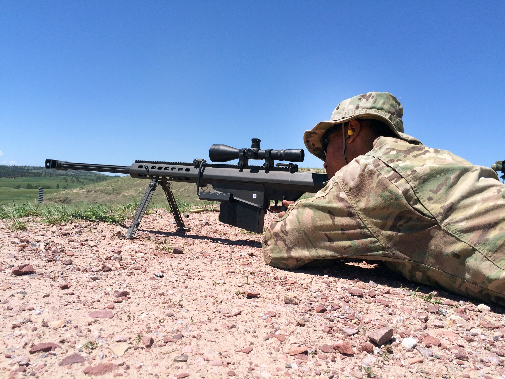 Senior Airman Jason Cathey, 90th Security Forces Group, fires a M107 on Camp Guernsey, Wyoming, while going through Nuclear Advanced Designated Marksman training June 16, 2015. Cathy has been selected for the Senior Leader Enlisted Commissioning Program—Active Duty Scholarship program and is slated to depart this fall to finish his degree and earn his commission as a second lieutenant in the Air Force. (Courtesy photo)