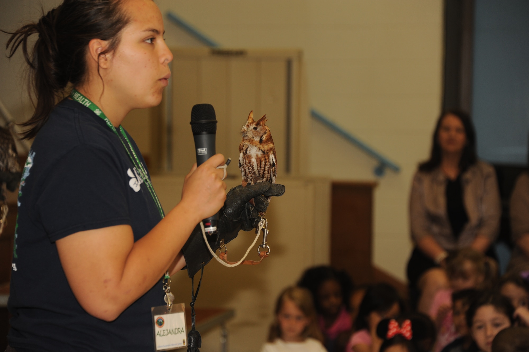 Alejandra Palacio, Alabama 4-H Science School environmental educational instructor, educates Maxwell Elementary and Middle School students about the Eastern Screech Owl during the Birds of Prey demonstration April 8, 2016, at Maxwell Air Force Base, Alabama. Palacio hopes that by educating young students about animals and their environment that it will strike an interest in them to conserve our resources and protect the wildlife. (U.S. Air Force photo by Airman 1st Class Alexa Culbert)