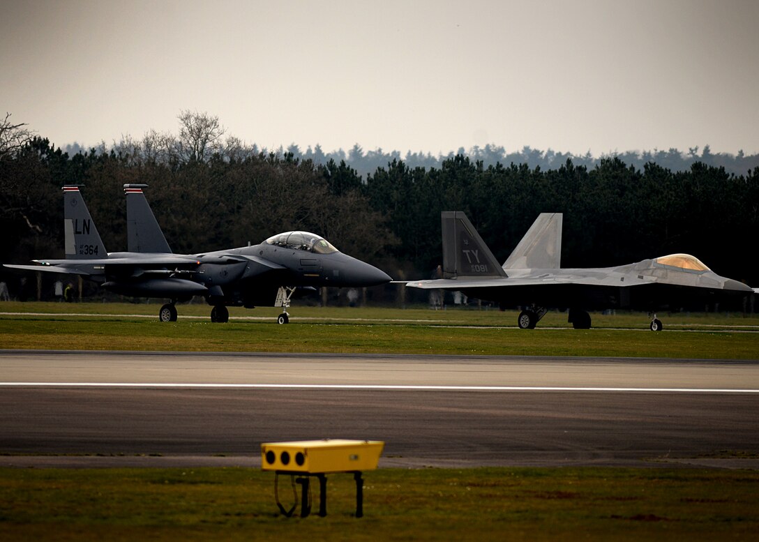 F-22 Raptors from the 95th Fighter Squadron land April 11, at Royal Air Force Lakenheath, 
England. The aircraft arrival marks the second time the U.S. European Command has hosted a deployment of F-22 aircraft in the EUCOM Area of Responsibility.  (U.S. Air Force photo/ Tech. Sgt. Matthew Plew)
