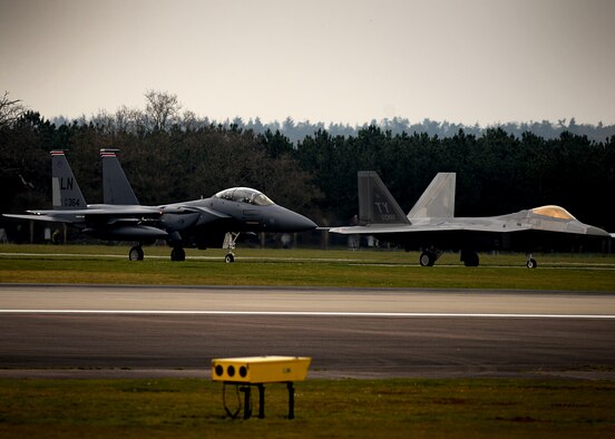 F-22 Raptors from the 95th Fighter Squadron land April 11, at Royal Air Force Lakenheath, 
England. The aircraft arrival marks the second time the U.S. European Command has hosted a deployment of F-22 aircraft in the EUCOM Area of Responsibility.  (U.S. Air Force photo/ Tech. Sgt. Matthew Plew)
