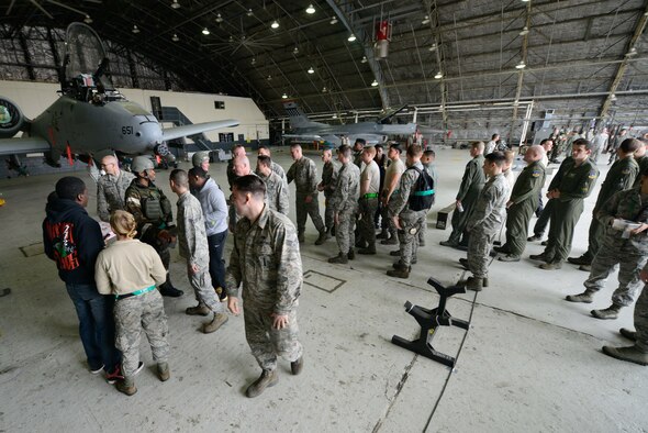 Attendees shake hands with competitors after a quarterly weapons load competition April 8, 2016, at Osan Air Base, Republic of Korea. Weapons load teams from the 25th and 36th Aircraft Maintenance Units competed in dress and appearance, timing and technical order accuracy during the competition. (U.S. Air Force photo by Senior Airman Dillian Bamman/Released)