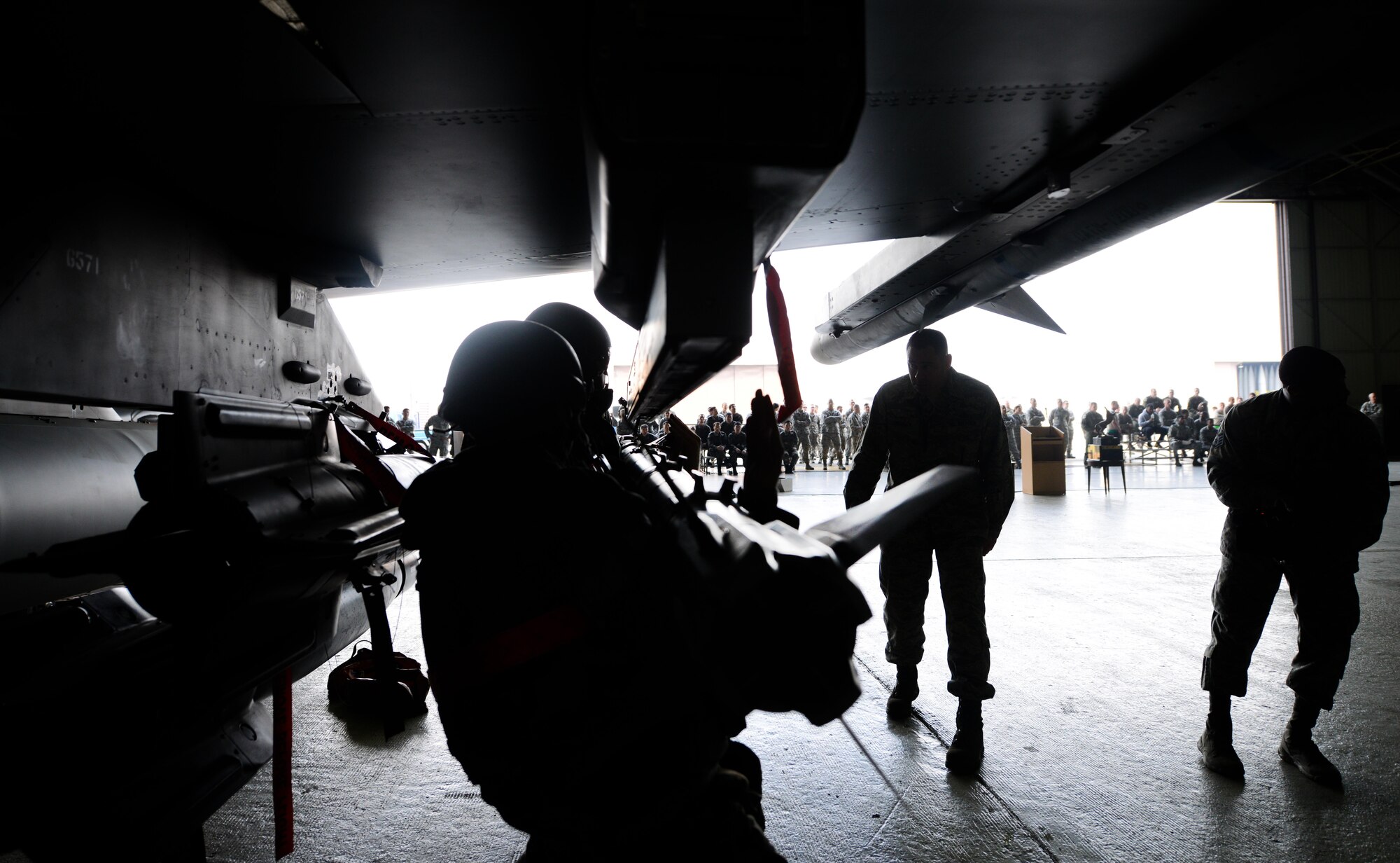 Airmen from the 36th Aircraft Maintenance Unit load an AIM-9 Sidewinder onto an F-16 Fighting Falcon during a quarterly weapons load competition April 8, 2016, at Osan Air Base, Republic of Korea. Weapons load teams from the 25th and 36th AMUs competed by loading three training bombs and one missile onto their respective aircraft during the event. (U.S. Air Force photo by Senior Airman Dillian Bamman/Released) 