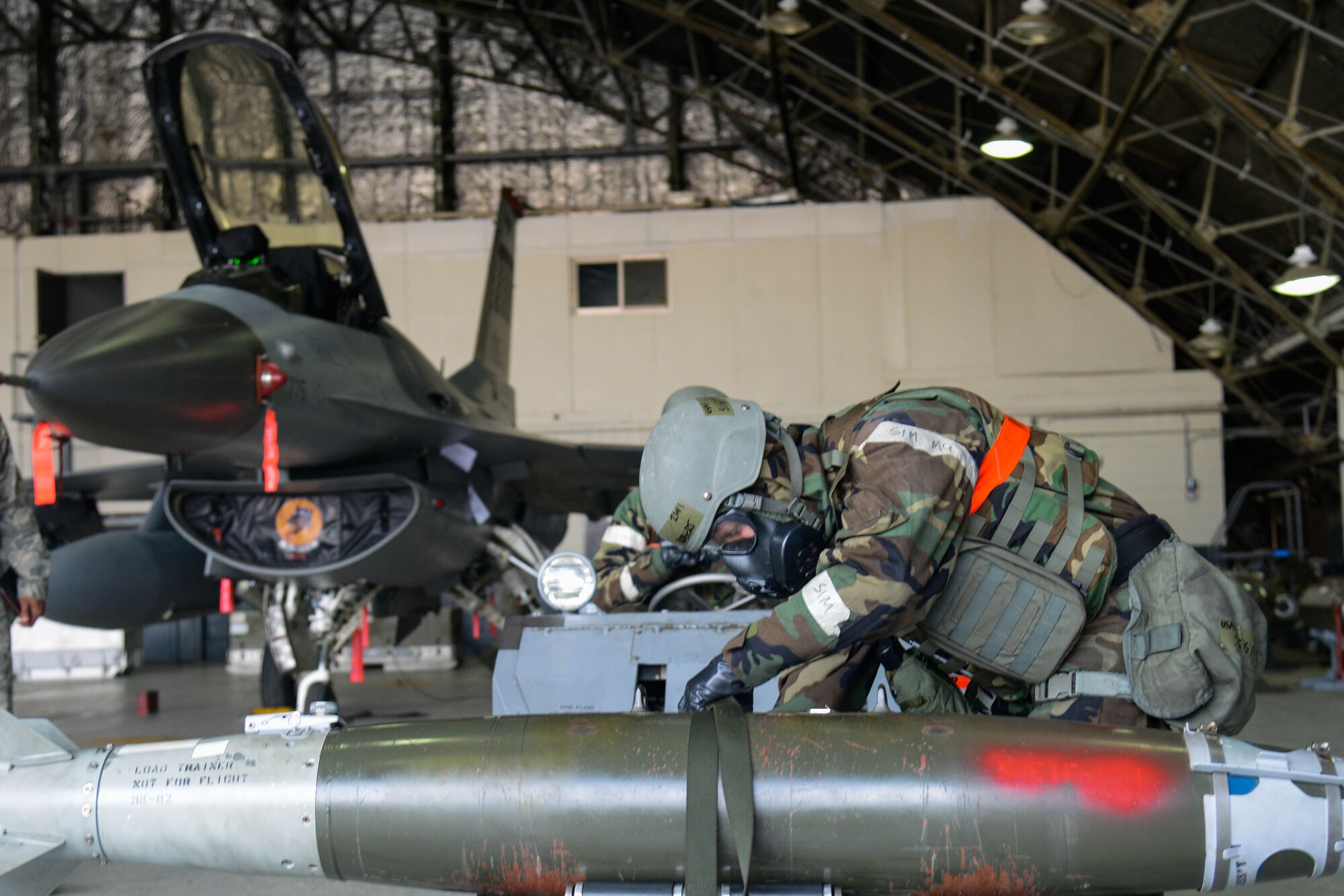 Staff Sgt. Robert Olsen, 36th Aircraft Maintenance Unit, prepares a Mark 82 training bomb to load onto an F-16 Fighting Falcon during a quarterly weapons load competition April 8, 2016, at Osan Air Base, Republic of Korea. Weapons load teams from the 25th and 36th AMUs competed by loading three training bombs and one missile onto their respective aircraft during the event.  (U.S. Air Force photo by Senior Airman Dillian Bamman/Released)