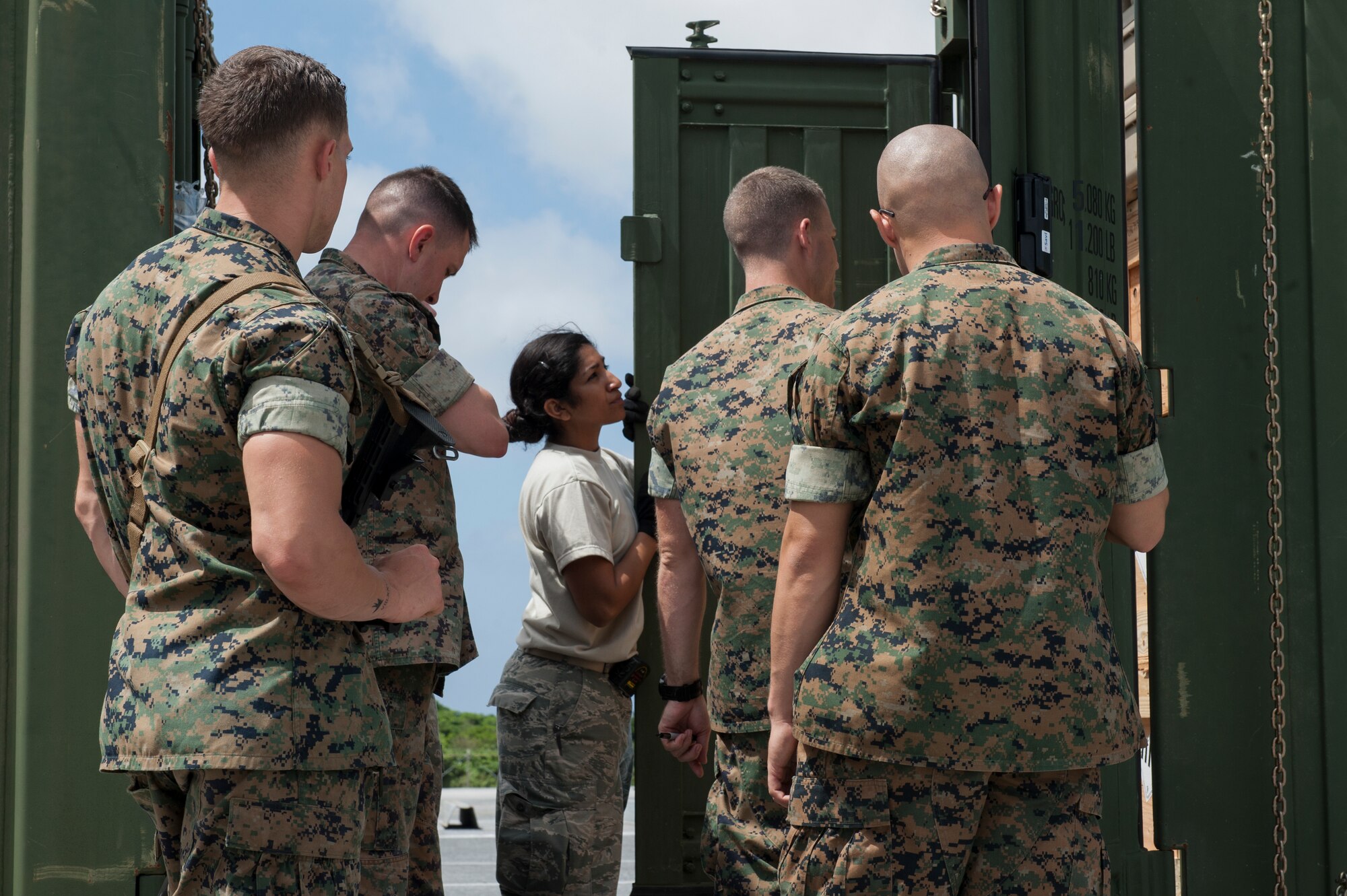 U.S. Air Force Staff Sgt. Lincy Thomas, 733rd Air Mobility Squadron joint inspection program manager and shift supervisor of aircraft services, inspects cargo during a joint inspection April 7, 2016, at Kadena Air Base, Japan. During this joint inspection, the Marines prepared their cargo for embarkation so the Air Force could inspect it before it went on Air Force aircraft. (U.S. Air Force photo by Airman 1st Class Lynette M. Rolen)