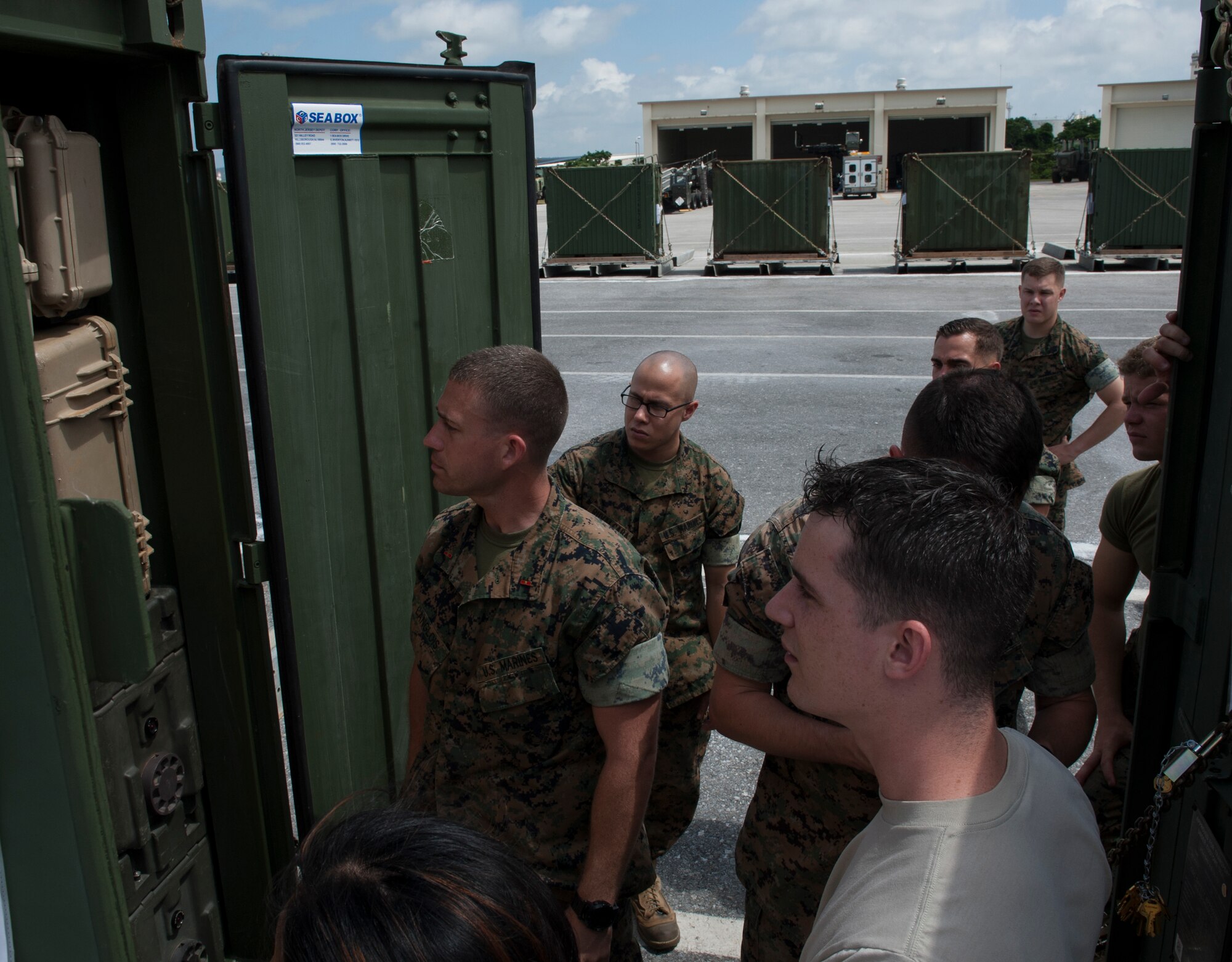 U.S. Marine Corps Warrant Officer Matthew Langlois, 4th Marine Regiment, 3rd Marine Division mobility officer, discusses cargo specifications with members of a joint inspection team April 7, 2016, at Kadena Air Base, Japan. Although Marine and Air Force load rules and regulations differ, the team was able to work together and carry out the inspection. Prior to going on Air Force aircraft, the inspection needs to take place to ensure the cargo is at Air Force standards. (U.S. Air Force photo by Airman 1st Class Lynette M. Rolen)