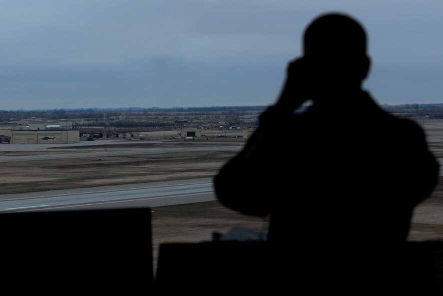A 5th Operations Support Squadron Airman from the Air Traffic Control tower at Minot Air Force Base, N.D., watches a helicopter land April 6, 2016. The primary responsibility of controllers is to support the nuclear mission through separation of aircraft and provide expeditious service to Team Minot. (U.S. Air Force photo/Airman 1st Class Jessica Weissman)